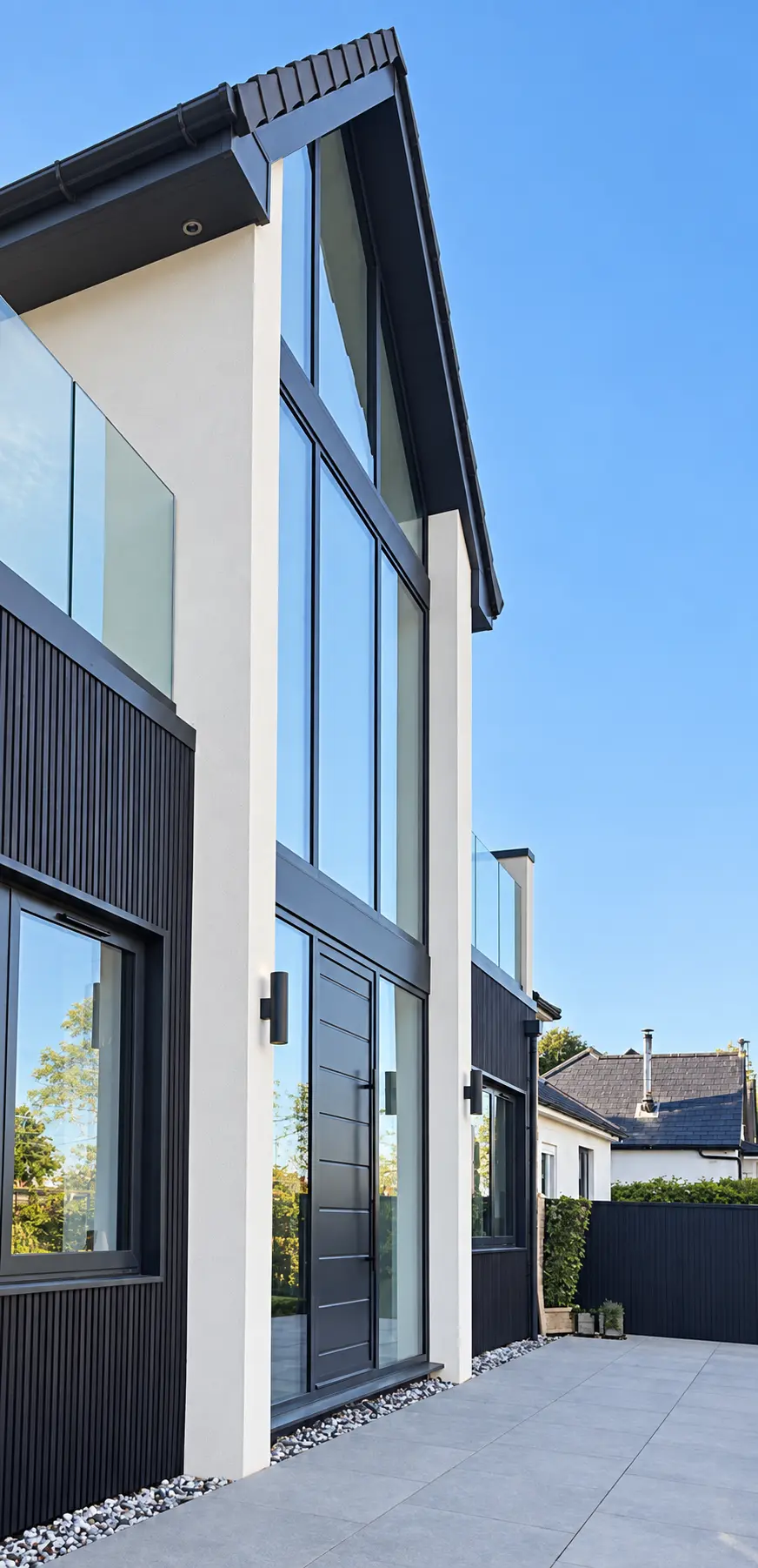 Close exterior view of the tall aluminium and glass gable feature wall