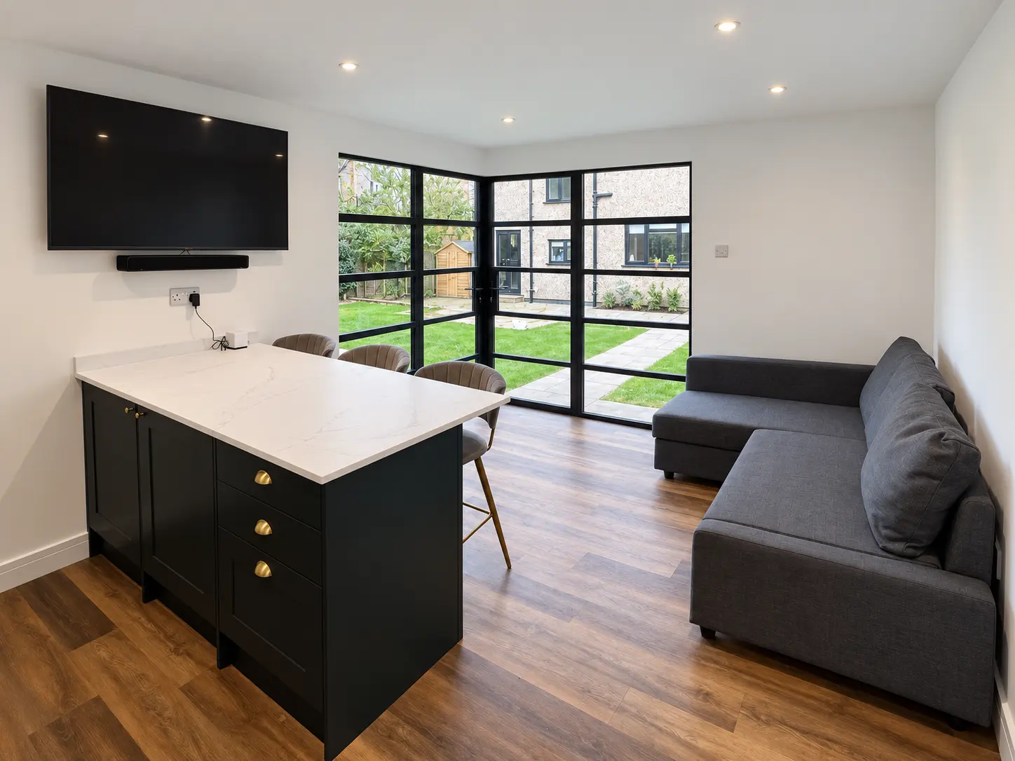 Finished garden-room interior with heritage aluminium corner doors and windows