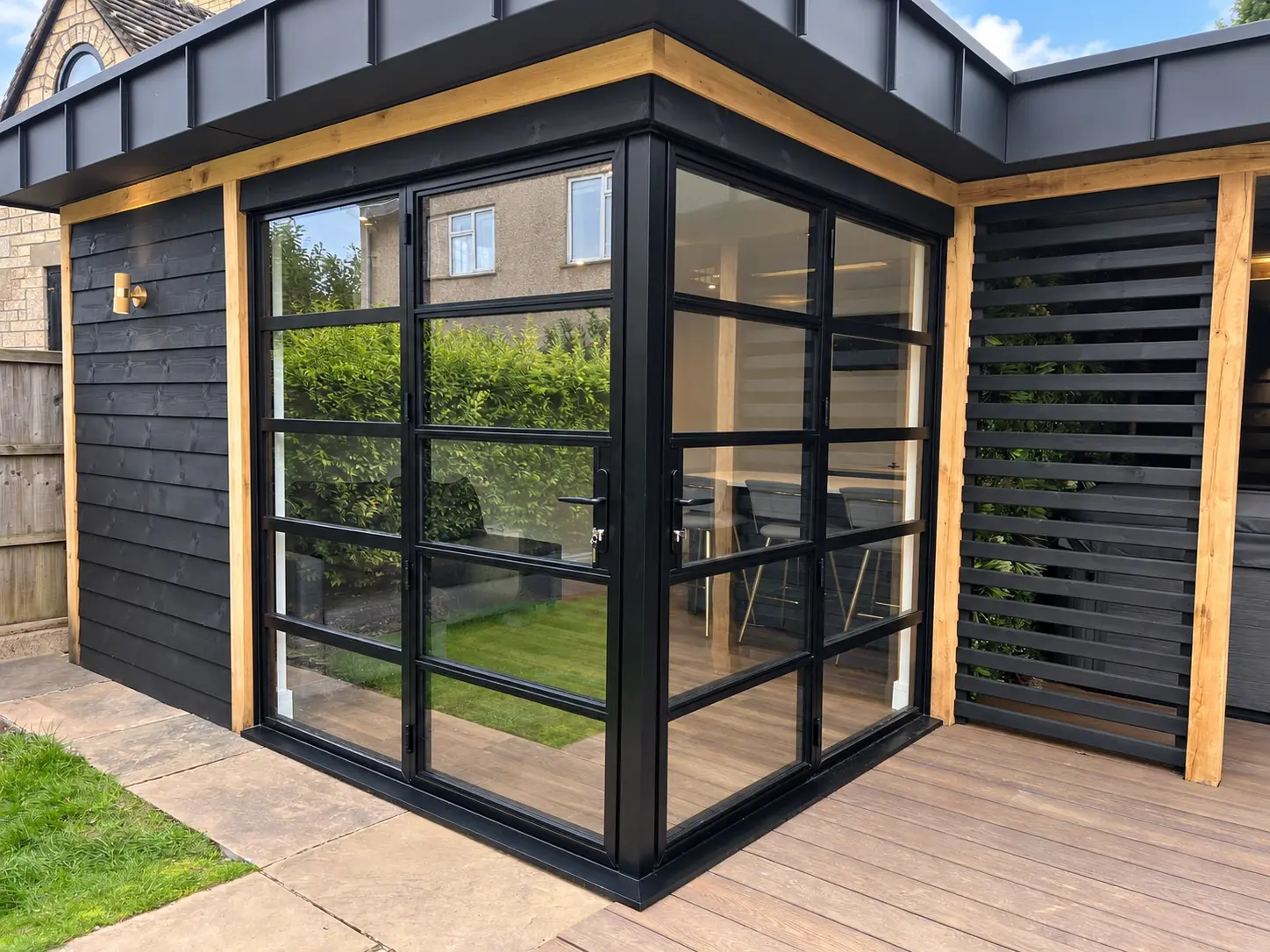 Close view of heritage aluminium doors and matching windows meeting around the corner
